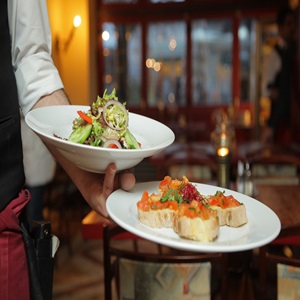 Image of waiter serving in a restaurant